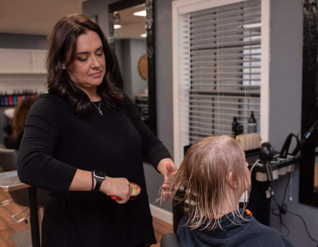 Hair stylist cutting a client's hair