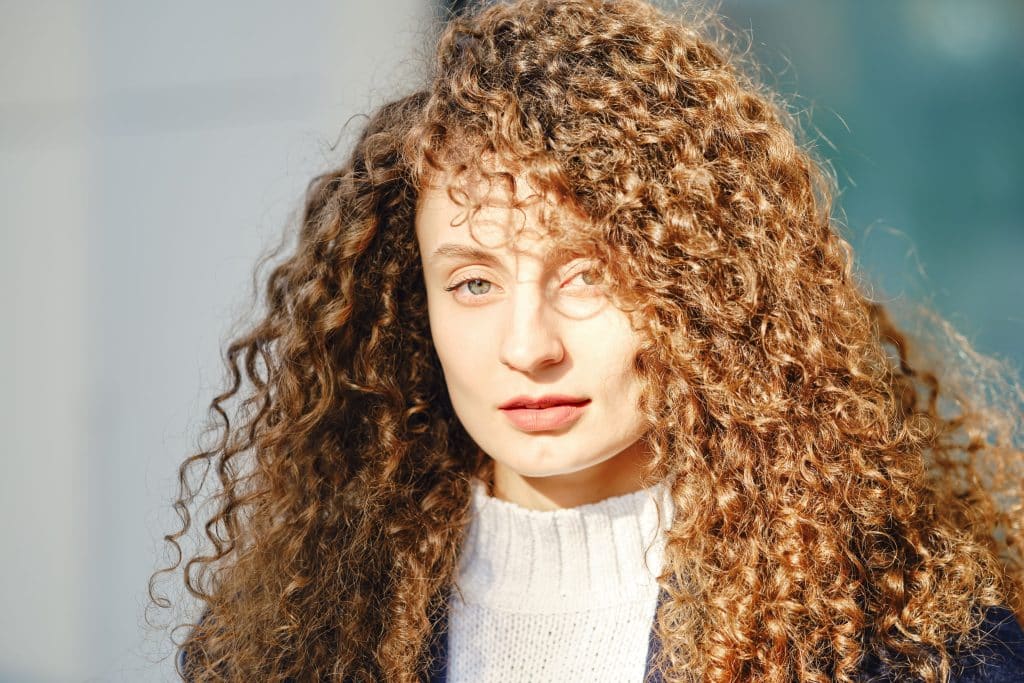 Close up of a woman with long curly hair